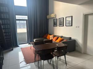 a living room with a table and a couch at Royal Luxury Apartments in Accra