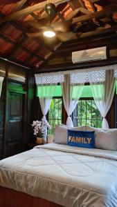 PenagaにあるKampung Cheq Homestay - Private Pool, Free Wifi, Netflixのベッドルーム1室(大型ベッド1台、ファミリーサイン付)