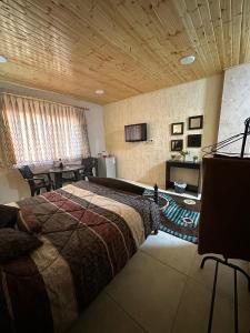 a bedroom with a large bed and a table at Green Garden Rooftop in Madaba
