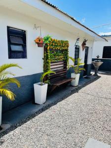 a bench covered in flowers next to a building at Nômade no Liberdade in Boa Vista