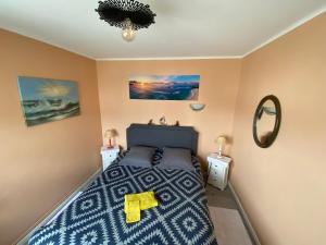 a bedroom with a bed and two night stands at Chez Armelle in Hesdin