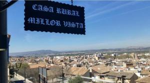 a view of a city with a sign in the foreground at Casa Millor Vista, Rooms in Xàtiva