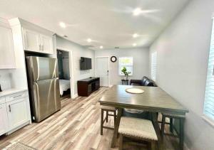 a kitchen and living room with a table and a refrigerator at Downtown West Palm Apartment Near Airport in West Palm Beach