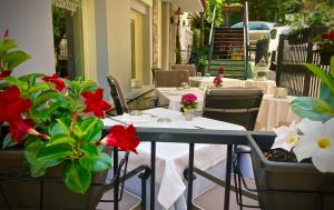 a table and chairs with flowers on a patio at Antiche Mura in Riva del Garda
