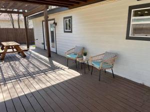 two chairs and a table on a porch at Brentwood de Maria -Cowboy Pool & Dog Friendly in Austin