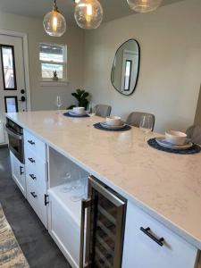 a kitchen with a counter with wine glasses on it at Brentwood de Maria -Cowboy Pool & Dog Friendly in Austin