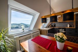 a kitchen with a table and a large window at Renatas Ferienwohnung Sasbachwalden in Sasbachwalden