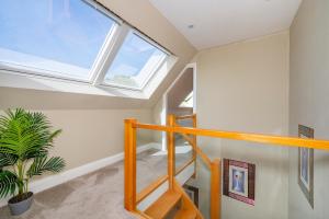a skylight in a room with a staircase and a window at *RA7C* For your most relaxed & Cosy stay + Free Parking + Free Fast WiFi * in Batley