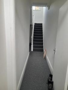 a hallway with a stairway with a stair case at ACCANE in Monkwearmouth