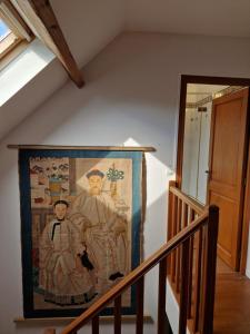a tapestry hanging on a wall in a stairway at Countryhouse close to Senlis and Parc Asterix in Thiers-sur-Thève
