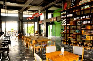 a restaurant with wooden tables and chairs and bottles of wine at Yunus Beach Hotel in Marmaris