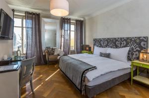 a bedroom with a large bed and a television at La Maison d'Igor in Morges