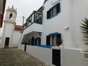 een wit en blauw gebouw met een klokkentoren bij Appartement Salir do Porto in Salir de Porto