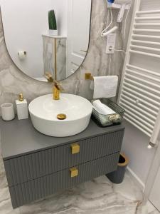 a bathroom with a sink and a mirror at Elite Apartment in Sibiu +22 photos