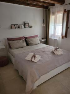a bedroom with a large bed with towels on it at CA' SEBASTIANO in Venice