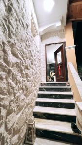 a stone wall with stairs leading to a door at Luxury Villa Prada in Skriperón