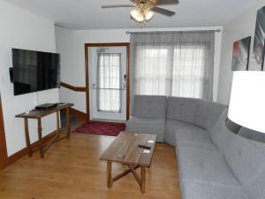 a living room with a couch and a table at Equipped condo on St-Pierre Lake, Kamouraska RCM in Mont-Carmel