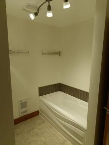 a bathroom with a bath tub in a room at Equipped condo on St-Pierre Lake, Kamouraska RCM in Mont-Carmel