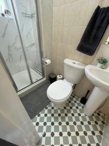 a bathroom with a toilet and a sink and a shower at London Guest Studios 8 in London