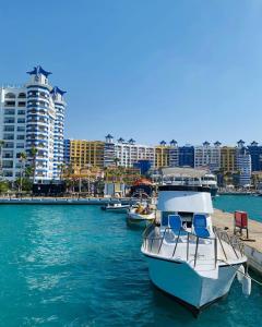 a boat is docked at a dock in the water at PORTO MARINA TOWERS SEA & POOL VIEW North Coast in El Alamein