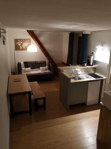 a kitchen with a sink and a table in a room at Hypercentre résidence paisible in Fontainebleau