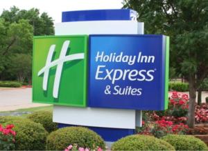 a sign for a huddley inn express and suites at Holiday Inn Express & Suites Ormond Beach - North Daytona by IHG in Ormond Beach