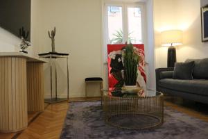 a living room with a couch and a table with a cactus at Trevi Fountain Luxury Flat in Rome