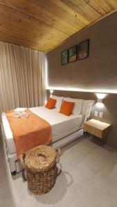 a bedroom with a large bed with orange pillows at Cobertura Milagres do Chef in São Miguel dos Milagres