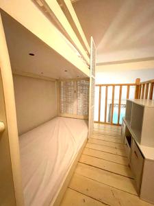 a room with a bed in the middle of a room at Duplex 3 piscines (1 chauffée/couverte) 300m plage in Les Sables Vignier