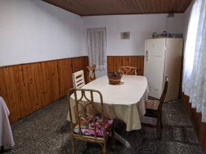 a kitchen with a table and a refrigerator at Casa en Pigue in Pigüé