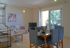 a living room with a table and chairs and a couch at KALIMERA Suite Kalamata II in Kalamata