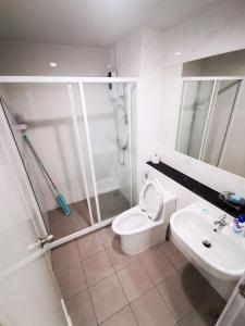 a bathroom with a shower and a toilet and a sink at Bangkok Sathon RYE condo in Bangkok