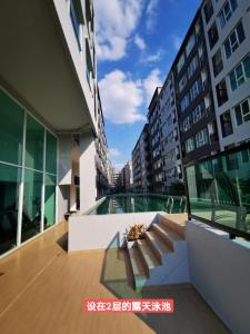 a balcony of a building with a view of a city at Bangkok Sathon RYE condo in Bangkok