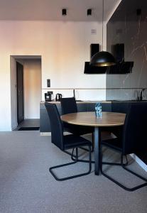 una sala da pranzo con tavolo e sedie in legno di Gamler Apartments by Letrent a Żyrardów