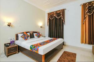 een slaapkamer met een groot bed en een raam bij Hotel 4 You - With Open Rooftop Cafe in Rishīkesh