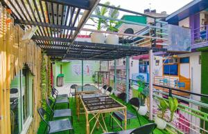 een balkon met tafels en stoelen in een gebouw bij Hotel 4 You - With Open Rooftop Cafe in Rishīkesh