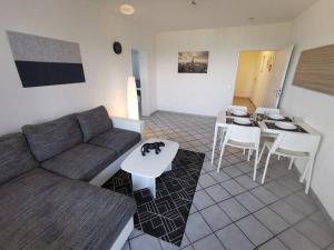 uma sala de estar com um sofá e uma mesa em Bright & Cozy Apartment em Plettenberg