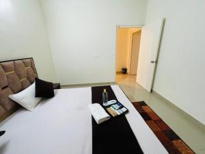 a room with a couch and a table with a bottle of wine at ACHYUTAM HOMES in Lucknow