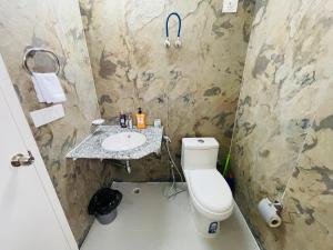 a bathroom with a toilet and a sink at ACHYUTAM HOMES in Lucknow +31 photos