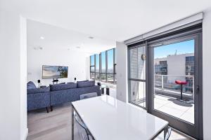 a living room with a couch and a large window at Oceanview 25th Floor Luxury Penthouse in Santa Ana