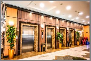 a row of elevators in a lobby with plants at فندق ديار الهدى in Al Madinah