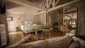 ein großes Schlafzimmer mit einem Bett und einem Tisch in der Unterkunft La Maison des Sources in Angoulême