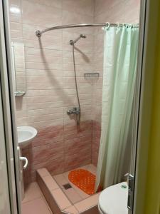 a bathroom with a shower with a toilet and a sink at Garni Bread House in Garni