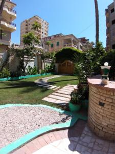 a backyard with a lawn and a walkway at Agami Guest House in Alexandria