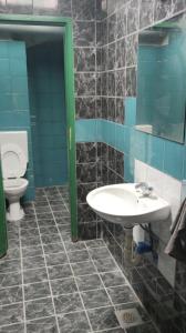 a bathroom with a sink and a toilet at Hostel UNDERGROUND in Maribor