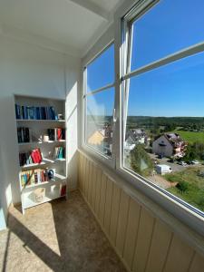 een kamer met een groot raam en een boekenplank bij Apartment mit Loggia und Traumblick 