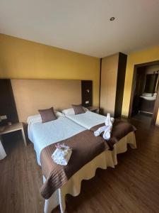 a bedroom with a large bed with a teddy bear on it at apartamento Laza in Laza
