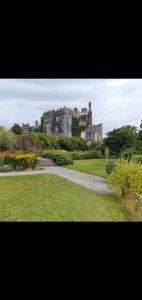 a castle sitting on top of a lush green field at Killooley Lodge in Tullamore