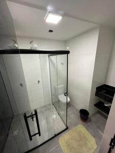 a bathroom with a glass shower and a toilet at Nasser Hotel Aeroporto in Núcleo Bandeirante