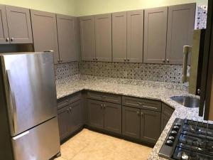 a kitchen with a stainless steel refrigerator and cabinets at CoHi - 102 in Washington, D.C.